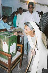 An old woman casts here vote during second phase of panchayat election