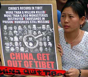 A Tibetan girl holds a placard in Bangalore