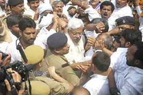 Senior RJD leader Shivanand Tiwari being arrested in Patna on Saturday as his supporters protest against the arrest.