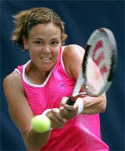 Lindsay Davenport returns a shot to Venus Williams