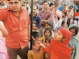Child beggars cajole devotees at the Mansa Devi shrine for alms during the Navratra fair at Panchkula