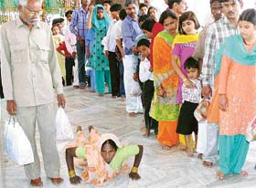 A woman does dandwat pranam at the Mansa Devi shrine in Panchkula