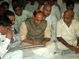 Senior BJP leader Rajnath Singh writes a condolence message at Om Prakash Jindals residence in Hisar on Sunday