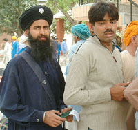 Anil Singh, leader of the Sindhi Hindu jatha, stands in a queue at the Wagah joint check point on Sunday.