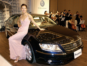 South Korean model poses next to Germanys Volkswagen Phaeton luxury sedan during its unveiling ceremony at Seoul on Monday. The Phaeton W12 priced at 150.6 million won ($ 1,48, 360) is equipped with 12-cylinder 6,000 cc engine.