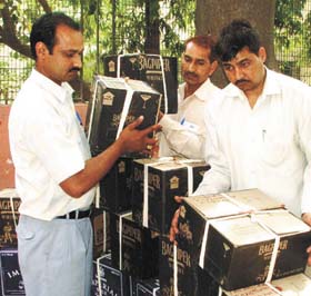 The Delhi Police Crime Branch officers showing as many as 3,000 bottles of illicit liquor at a press conference in the Capital