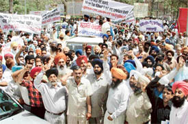 Members of the Punjab State Goods Transport Association stage a demonstration in front of the Deputy Commissioners office in Ludhiana