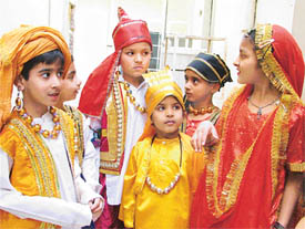 Students of Sanatan Vidya Mandir wait back stage fefore a fancy dress competition in Ludhiana on Tuesday