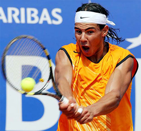 Rafael Nadal of Spain returns a backhand to Xavier Malisse of Belgium 