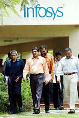 Nandan Nilekani, Chief Executive Officer, Infosys Technologies, (second from left), is accompanied by board directors on his way to a press conference to announce the annual results of the company 