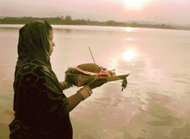 A woman offers Chhat pooja at Sukhna Lake in connection with Navratras in Chandigarh on Friday.