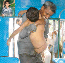 Lal Babu, uncle of eight-year-old Satish (inset) who had  fallen into Budda Nullah