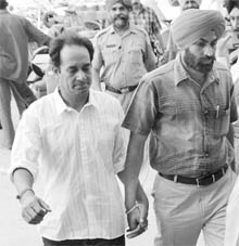 Joga Singh an accused in the Malta boat tragedy case (extreme left) being produced before the court by the CBI in Jalandhar on Friday.