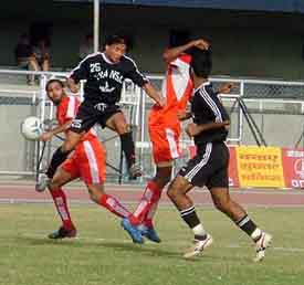 Fransa Pax FCs Saikhom Singh leaps into the air to clear the ball as JCTs Jaswinder Singh looks on in the ninth National Football League match at Ludhianas Guru Nanak Stadium on Friday
