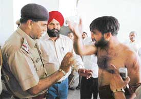 Independent candidate Navdeep Singh makes a point after a clash with the police at a polling booth in Ambala City on Saturday