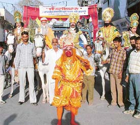 A devotee dressed as Lord Hanuman leads Shobha Yatra from Daresi ground