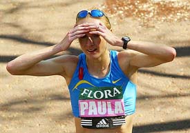 Britain's Paula Radcliffe shades her eyes after crossing the line to win the London Marathon