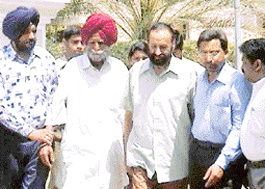 Major Gurinder Singh Bhullar (second from left) and driver Parkash Singh (third from right) in the custody of NCB officials in Chandigarh on Monday.