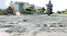 Potholes dot a road in Sector 38 (West), Chandigarh.