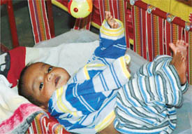 The baby waits to leave for her new home at the Niskham Shishu Ashram in Ludhiana on Monday