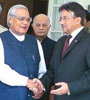 Pakistan President Pervez Musharraf shakes hands with former Prime Minister A.B. Vajpayee at his residence in New Delhi on Monday. 