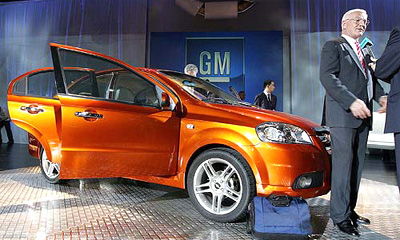 Robert A. Lutz, General Motors Vice-Chairman accepts interview as he stands near a model of Chevrolet Aveo which is making its worldwide debut at Auto Shanghai