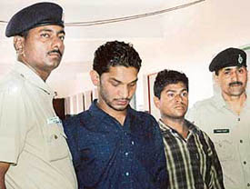 Sunil, alias Chikna, and Deepak at the Sector 36 police station in Chandigarh on Wednesday. 