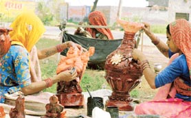 Rajasthani women prepare beautiful artefacts sitting on the roadside.