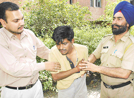 Policemen take an accused, who was caught red-handed stealing from  a house in Sector 7-B, Chandigarh, to the police station on Thursday.
