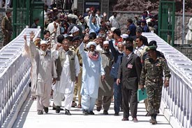 Passengers from Pakistan occupied Kashmir cross the Kaman bridge between India and Pakistan on the Line of Control on Thursday. 
