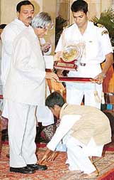 Vinod P. of Karnataka touches the feet of President A.P.J. Abdul Kalam during the National Bal Shree Award presentation function in New Delhi on Thursday.