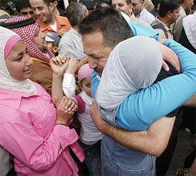 Jordanian prisoner Abdul Basant Dalasheh embraces his relative upon his arrival at King Hussein Bridge at Jordan's side of the Jordan River