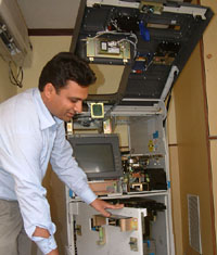 An employee of the Bank of India near the Golden Temple, Amritsar, checks the ATM machine on Friday.