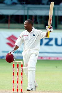 Brian Lara raises his bat after scoring a century against South Africa during the third Test at Kensington Oval in Bridgetown, Barbados, on Thursday