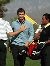 Australia's Adam Scott is congratulated by Spain's Sergio Garcia and Thailand's Thongchai Jaidee after the final hole of his first round at the 2005 Johnnie Walker Classic at the Pine Valley Golf Resort in Beijing
