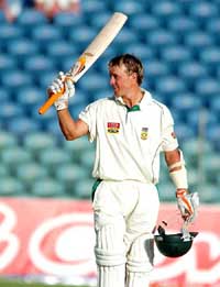 South African batsman Abraham de Villiers raises his bats after scoring a century against the West Indies on Friday