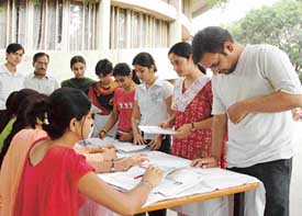 Students get information about the National Eligibility Test for lecturership, conducted by the University Grants Commission, at a camp at Panjab University Student Centre
