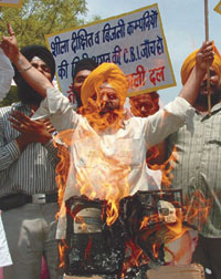 Activists of the National Akali Dal burning digital electronic meters and an effigy of Delhi Chief Minister Sheila Dikshit at Jantar Mantar in the Capital on Sunday.