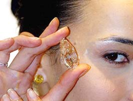 A model holds up a rare 120.20 carat pear-shaped faint brown diamond worth an estimated $ 8.2 lakh in Hong Kong on Monday. This is the largest diamond ever offered at an auction in Asia. This diamond is also the eighth largest pear-shaped diamond in the world.