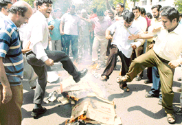 Agitating shopkeepers of Sector 15 market burn effigies of policemen in Sector 15, Chandigarh, on Monday.