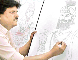 City-based artist Piratpal Goyal gives final touches to a portrait of Guru Gobind Singh. 