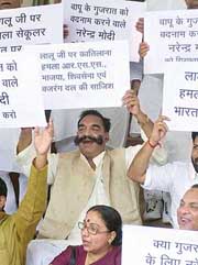 RJD MPs at the main gate of Parliament House in New Delhi on Monday against the attack on Railway Minister Laloo Prasad in Gujarat.