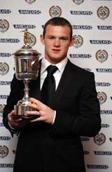 Manchester United and England striker Wayne Rooney holds the PFA Young Player of the Year trophy at the Grosvenor House Hotel in London on Sunday