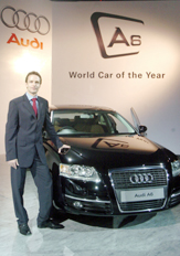 German luxury carmaker Audis country manager India, Michael Weber, poses with the Audi A6 after its launch in Mumbai on Tuesday. The latest car from the stables of Audi, a subsidiary of Volkswagen AG, A6 will be available in a 3-litre multitronic engine with front wheel drive at a price of Rs 46 lakh ($ 1,05,285). 