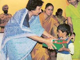 Ms Jean Rodrigues, wife of Punjab Governor and Administrator UT presents gifts to a sick child at the PGI Chandigah, on Tuesday