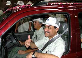 Maruti Udyog MD Jagdish Khattar and Joint MD S. Takeuchi take a ride on five millionth Maruti vehicle at its Gurgaon plant in Haryana on Wednesday. 