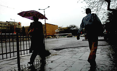 The woman was apparently prepared while the man was not, as the rains lashed the Capital on Wednesday afternoon