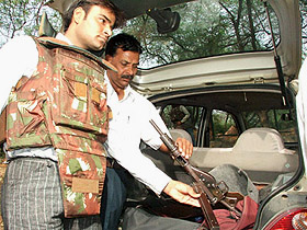 Police personnel showing a weapon seized after the encounter near Vasant Kunj in the Capital on Wednesday