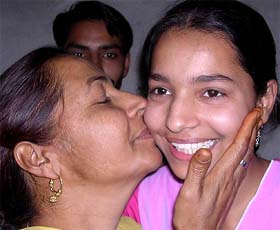 Pooja, who topped in the Punjab School Education Boards plus two (commerce) examination, being congratulated by her mother
