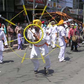 Sikh devotees perform martial art in the procession taken out on the eve of the birth anniversary of Guru Arjan Dev in Amritsar